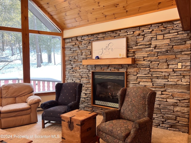 interior space with a stone fireplace, lofted ceiling, and wood ceiling