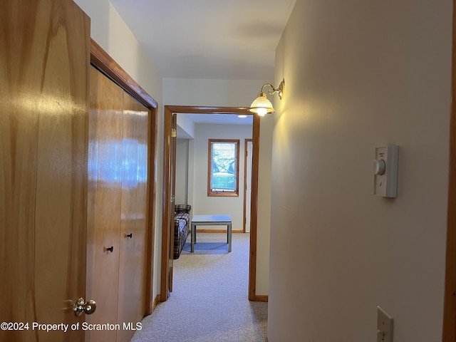 hallway with light colored carpet