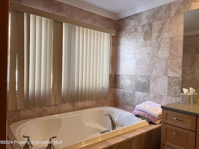 bathroom featuring vanity, tiled bath, tile walls, and ornamental molding