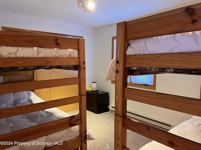 bedroom featuring carpet and a baseboard heating unit