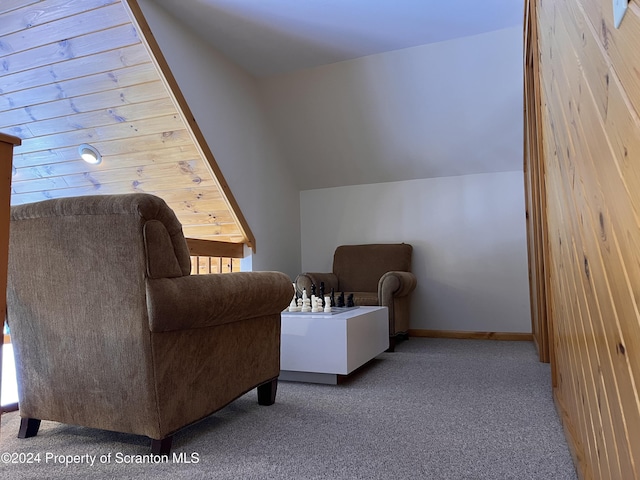 living area with light colored carpet and vaulted ceiling