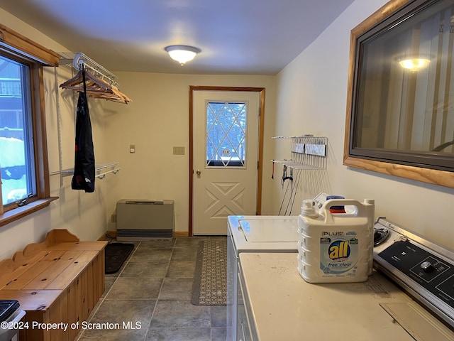 laundry area featuring washing machine and dryer and heating unit