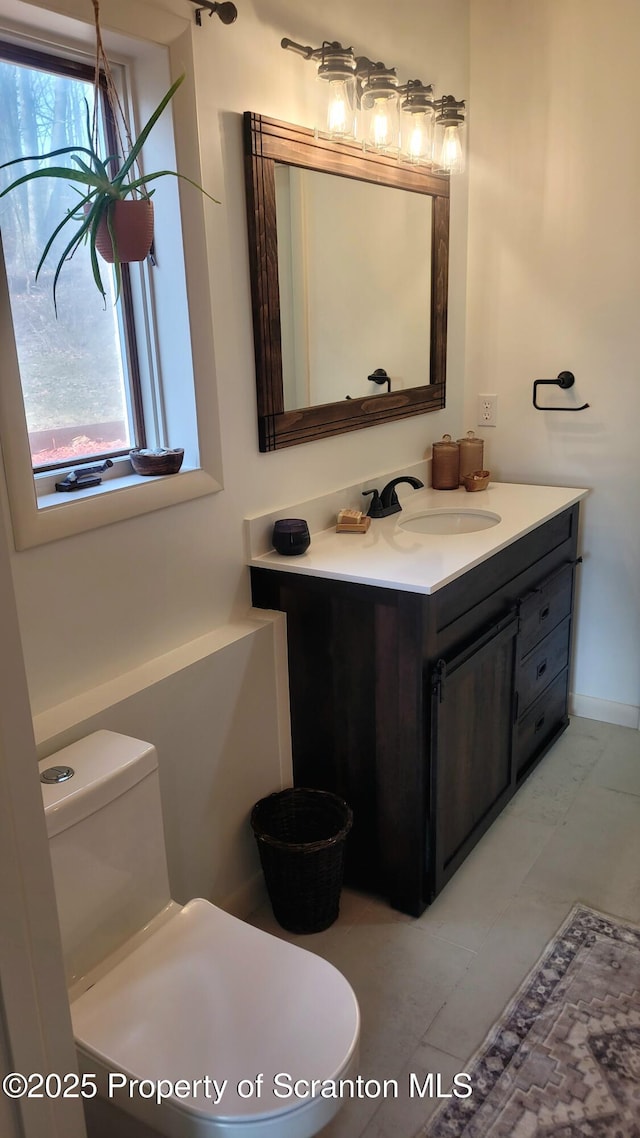 bathroom featuring toilet and vanity
