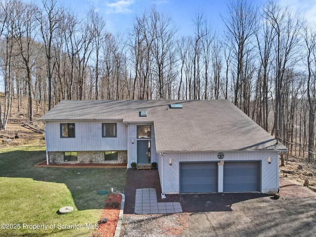 view of front of home with a front yard and roof with shingles