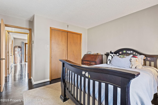 interior space with a textured ceiling and wood finished floors