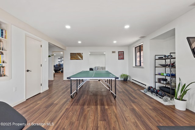 bedroom with multiple windows, a textured ceiling, wood finished floors, and access to exterior