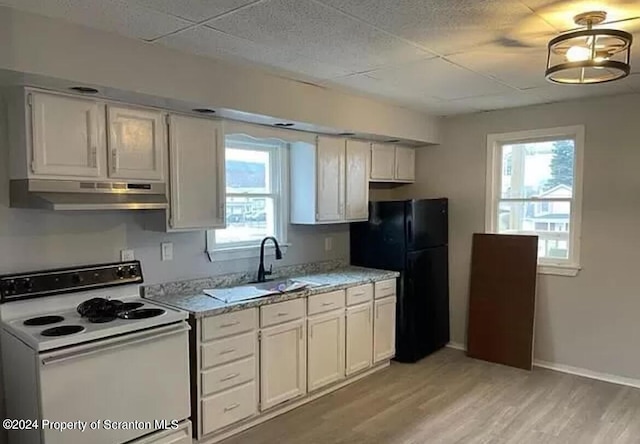 kitchen with light hardwood / wood-style flooring, white cabinets, and white range with electric cooktop