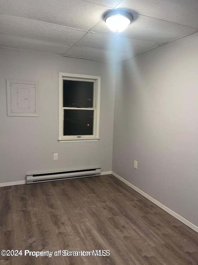 unfurnished room featuring dark hardwood / wood-style floors and baseboard heating