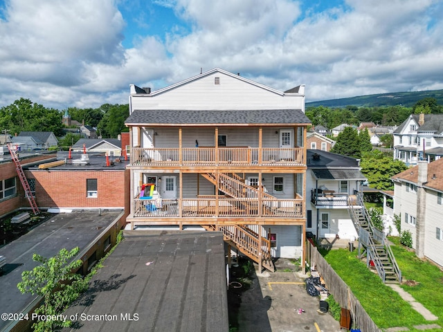 back of property featuring a balcony