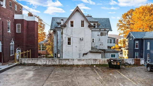 rear view of house with uncovered parking