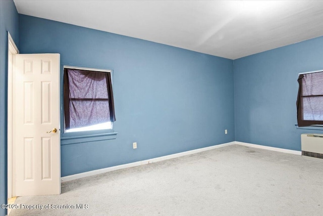 unfurnished room with carpet flooring and baseboards