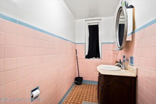 bathroom with tile patterned floors, vanity, and tile walls