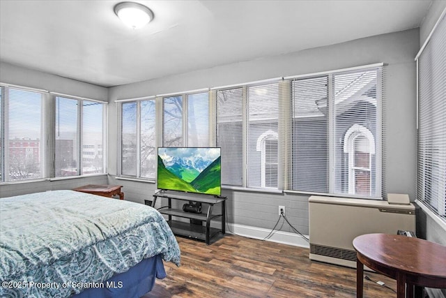 bedroom featuring baseboards and wood finished floors