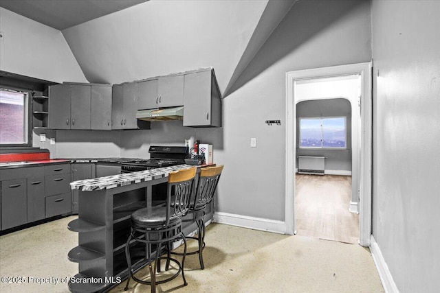 kitchen with black range with gas cooktop, lofted ceiling, gray cabinets, under cabinet range hood, and open shelves