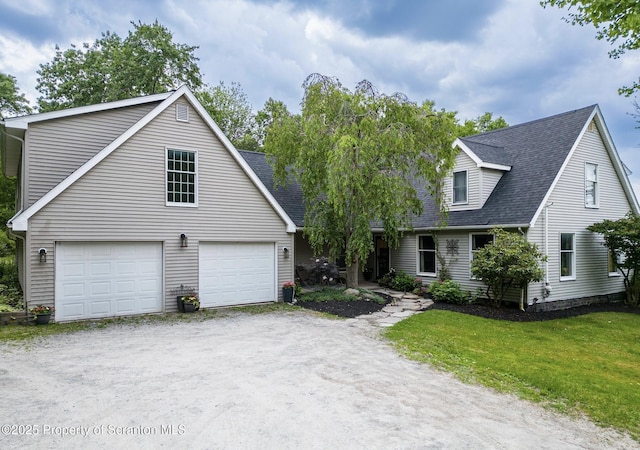 cape cod home featuring driveway, a front yard, a garage, and roof with shingles