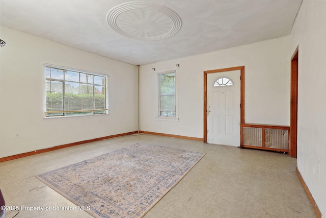 foyer with tile patterned floors and baseboards