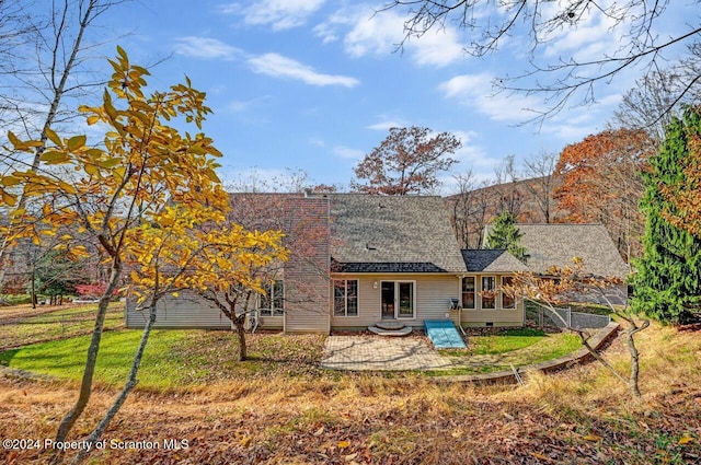 back of property featuring a yard