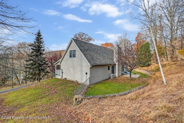 view of property exterior with a lawn