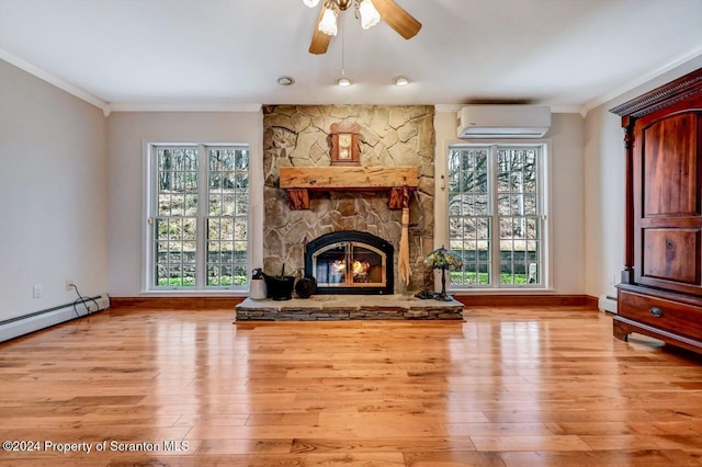 unfurnished living room featuring light hardwood / wood-style flooring, ceiling fan, ornamental molding, a fireplace, and a wall unit AC