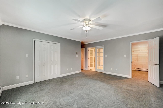 unfurnished bedroom with carpet flooring, ceiling fan, baseboard heating, crown molding, and a closet