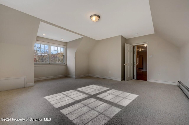 bonus room featuring light colored carpet, baseboard heating, and lofted ceiling