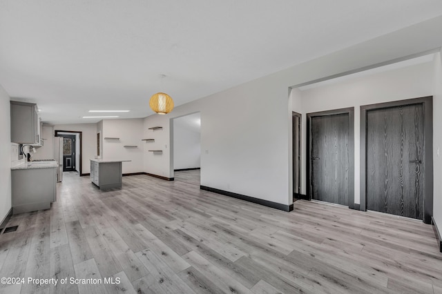 unfurnished living room with light hardwood / wood-style floors