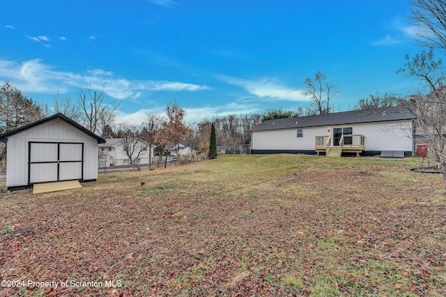 view of yard with a storage unit and a deck