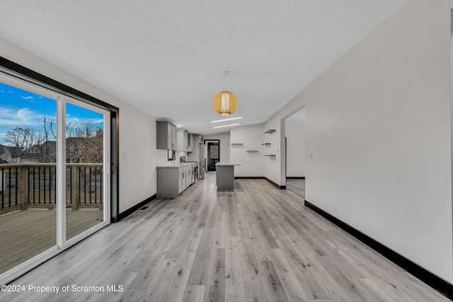 unfurnished living room featuring light wood-type flooring and lofted ceiling