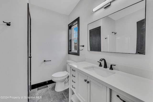 bathroom featuring a shower, vanity, and toilet