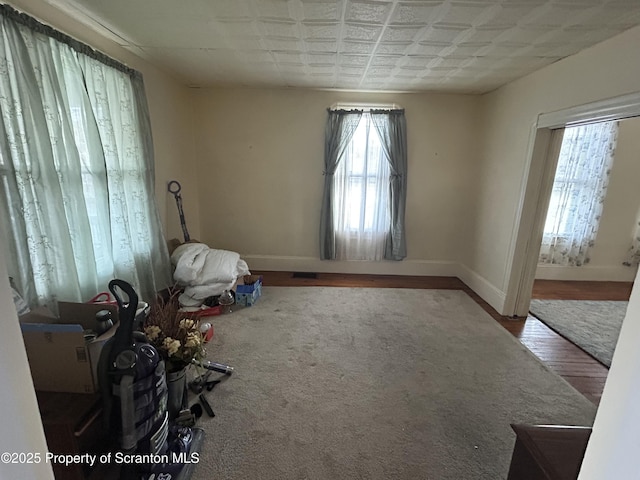 interior space with baseboards and wood finished floors