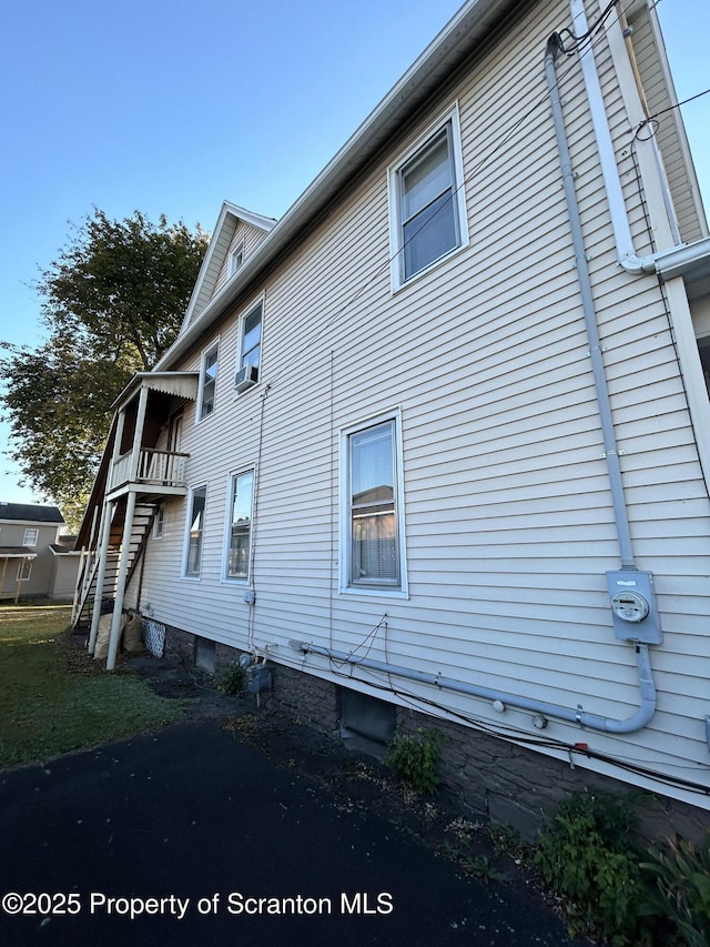 view of side of property featuring stairway