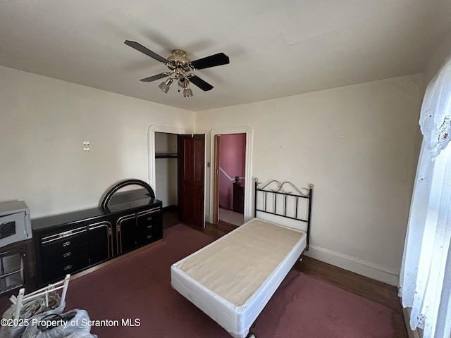 bedroom featuring ceiling fan and baseboards