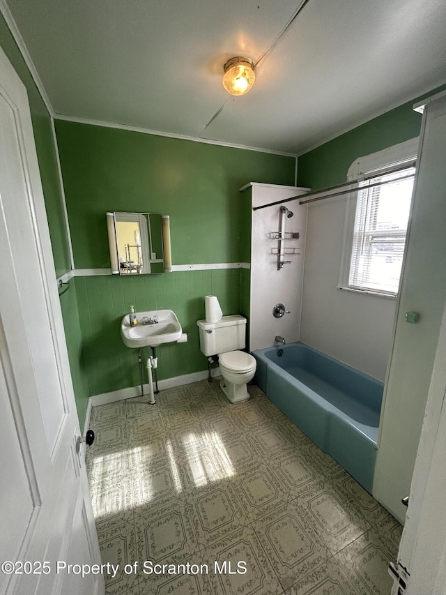 full bathroom with toilet, shower / tub combination, and wainscoting