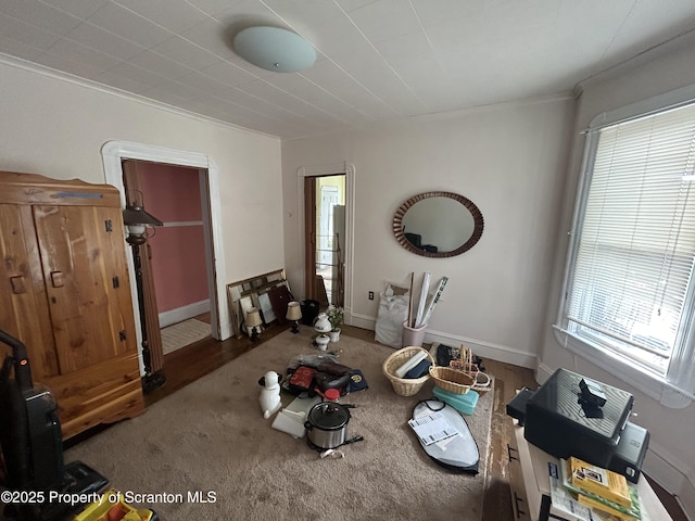 interior space with baseboards and crown molding