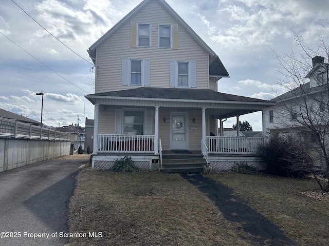 view of front of home featuring a shingled roof and covered porch