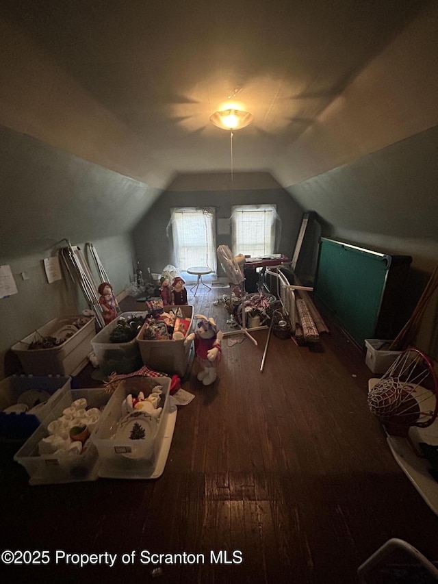 additional living space featuring hardwood / wood-style flooring and vaulted ceiling