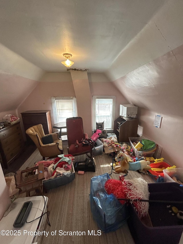 additional living space featuring vaulted ceiling and wood finished floors