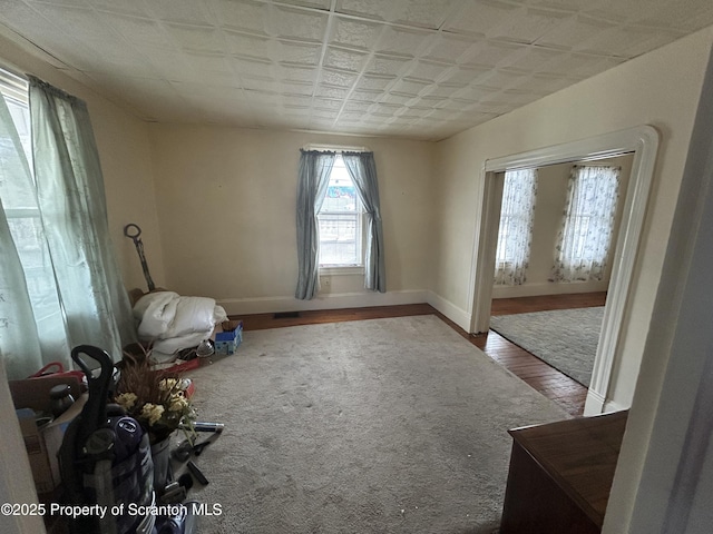 empty room with wood finished floors and baseboards