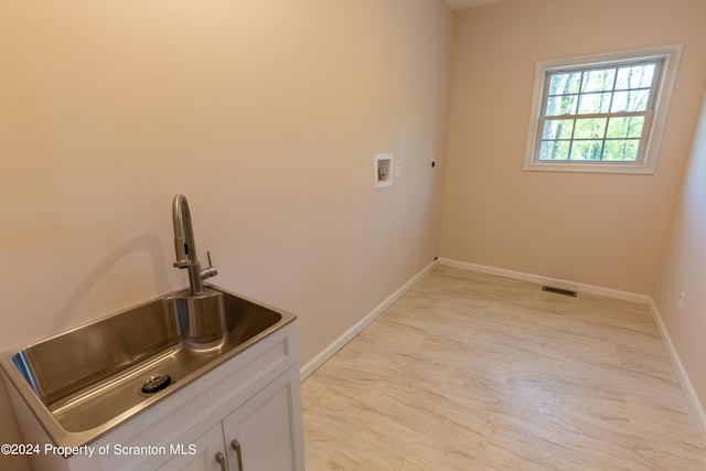 washroom with washer hookup, cabinets, and sink