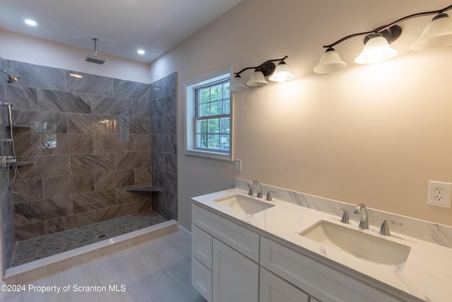 bathroom featuring vanity and tiled shower