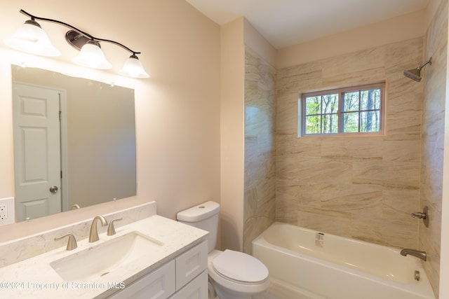 full bathroom with tiled shower / bath, vanity, and toilet