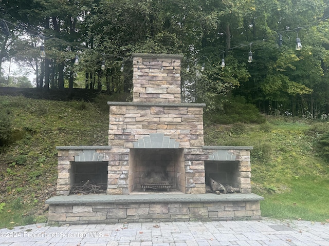 exterior details with an outdoor stone fireplace