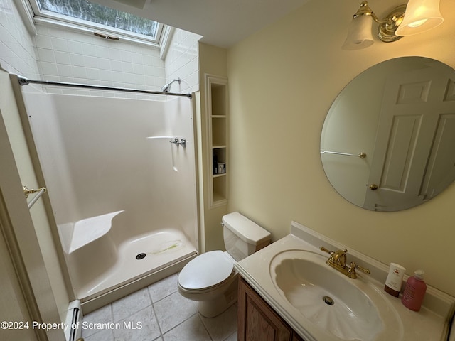 bathroom with vanity, a shower, a baseboard heating unit, tile patterned floors, and toilet