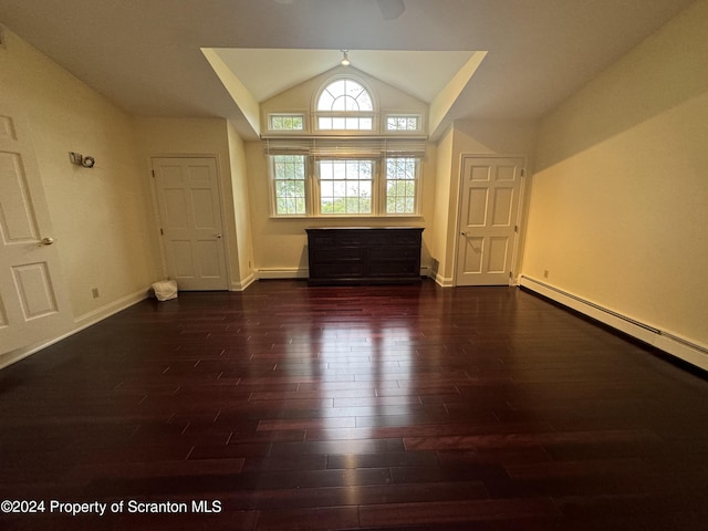 unfurnished living room with vaulted ceiling, dark wood-type flooring, and a baseboard radiator