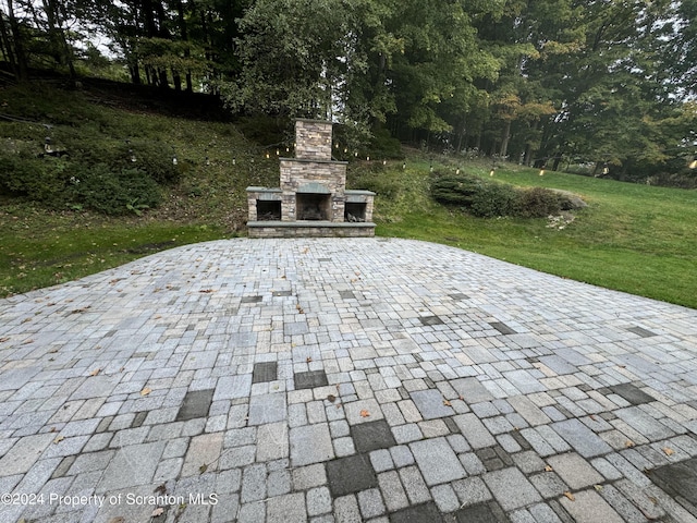 view of patio / terrace featuring an outdoor stone fireplace