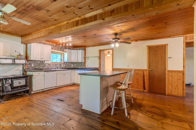 2269 Creek Rd, New Milford, PA 18834 - kitchen with ceiling fan, dishwasher, dark countertops, hardwood / wood-style floors, and a wainscoted wall