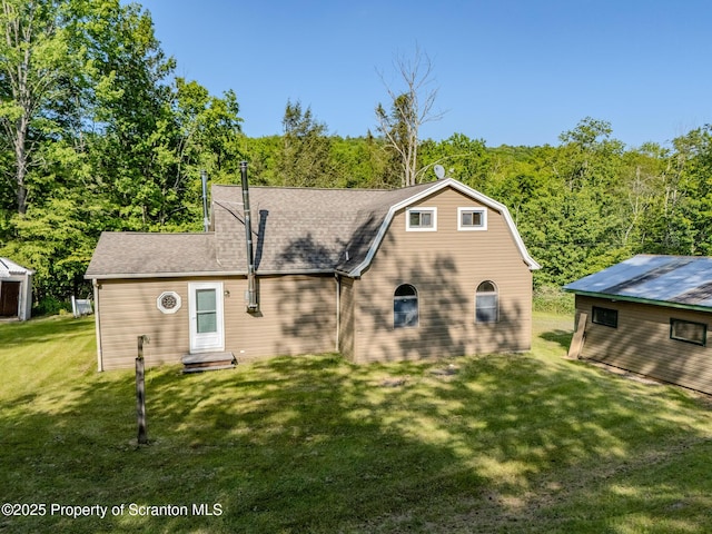 2269 Creek Rd, New Milford, PA 18834 - back of house with a yard, a wooded view, and roof with shingles