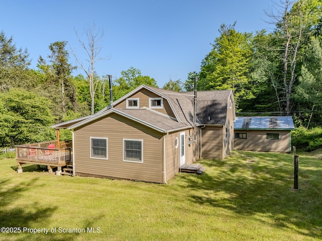 2269 Creek Rd, New Milford, PA 18834 - back of property with a lawn, a deck, and a shingled roof