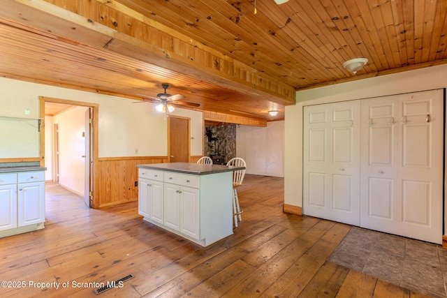 2269 Creek Rd, New Milford, PA 18834 - kitchen with a wainscoted wall, a kitchen island, light wood-style flooring, ceiling fan, and white cabinets
