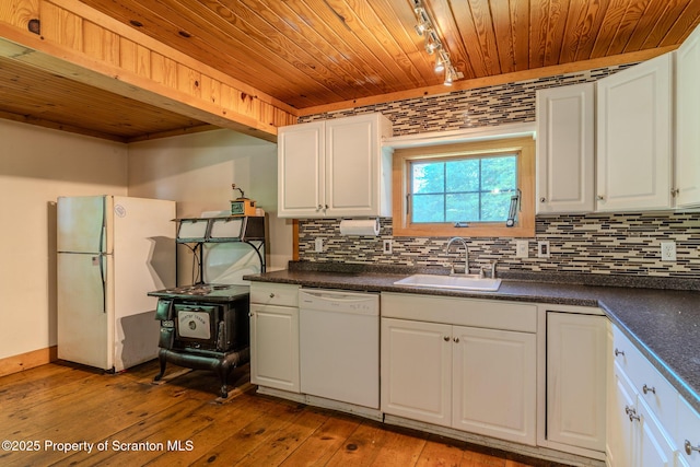 2269 Creek Rd, New Milford, PA 18834 - kitchen with white appliances, rail lighting, a sink, wood ceiling, and dark countertops